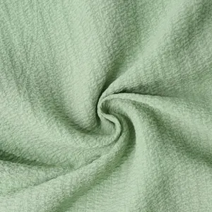 Macro texture of soft green breathable fabric for men's summer solid color shirts