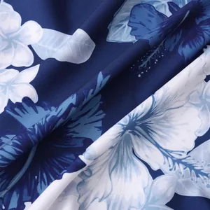 Close-up of tropical hibiscus floral print on navy blue fabric for beach shirts