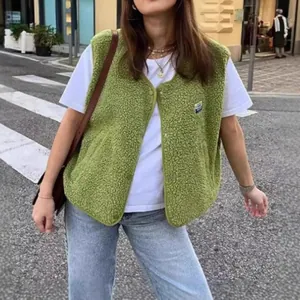 Casual women's green fleece vest jacket styled with white t-shirt and denim jeans