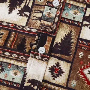 Close-up macro detail of men's holiday beach shirt with rustic forest print and white buttons