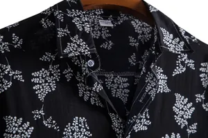 Close-up detail showing the collar and fabric texture of a black floral print shirt