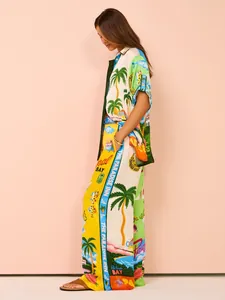 Detailed view of a vibrant tropical print vacation set with palm trees and retro graphics.