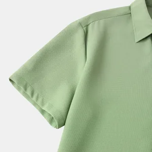 Close-up detail of a light green waffle textured men's short sleeve casual shirt