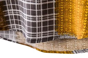 Detailed close-up view of a cotton linen casual shirt hem with plaid and chevron patterns