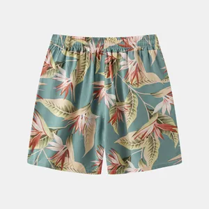 Full detail view of men's cotton linen beach shorts featuring a tropical floral print