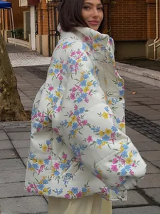 Detailed view of the vibrant floral pattern on the oversized white puffer jacket