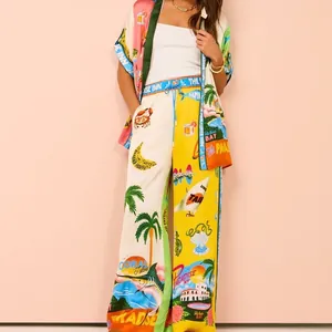 Full view of colorful tropical print resort set including kimono top and wide-leg pants.