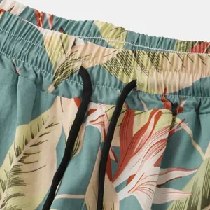 Close-up of tropical floral print beach shorts with elastic waistband and black drawstring