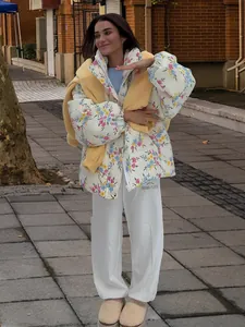 Street style floral puffer jacket with white sweatpants and beige platform clogs.