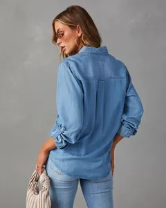 Back view of a classic blue denim shirt for women with a casual fit and soft texture