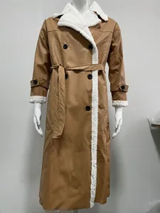 Cappotto lungo in ecopelle marrone con profili in shearling bianco e cintura da donna.