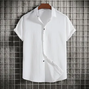 Macro detail of men's white short-sleeved button-down shirt featuring textured fabric