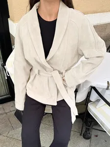 Detailansicht einer schicken beigen Wildlederimitat-Jacke mit stilvollem Bindegürtel