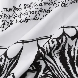 Close-up of white fabric with black script and cat print for men's Halloween casual shirt