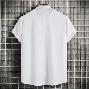 Detailed back view of a men's white short-sleeve shirt with textured fabric and relaxed fit.