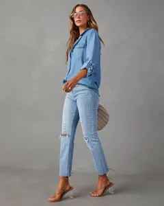 Casual long-sleeved light blue denim shirt with button-down front and chest pockets