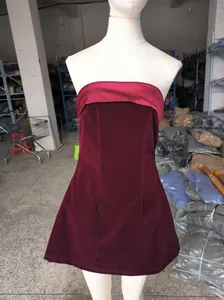 Detail view of a stylish burgundy velvet strapless mini dress displayed on a white mannequin torso.