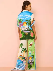 Stylish two-piece resort set with vibrant tropical print shirt and wide-leg trousers