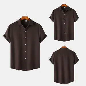 Detailed view of men's short-sleeved brown button-down shirt with textured fabric