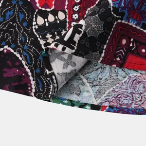 Macro detail of multi-color Hawaiian print fabric showing woven texture on a shirt