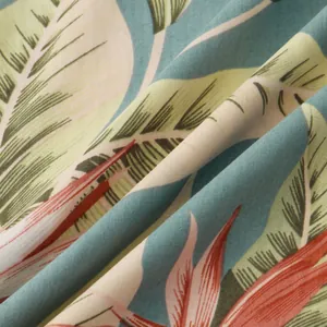 Macro detail of tropical floral print on breathable linen cotton shorts fabric.