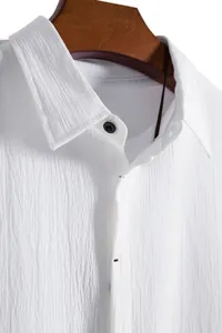 Close-up of white men's short-sleeved shirt with textured fabric and button collar