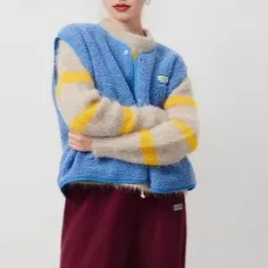 Close-up detail of a cozy blue fuzzy fleece vest featuring a single-breasted button front