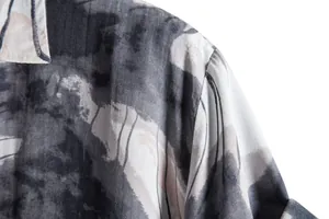 Close-up detail of grey and black abstract striped print on men's casual shirt shoulder area.