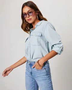 Chic women's light blue long-sleeve denim shirt featuring flap chest pockets and buttons