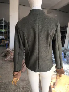 Detailed back view of vintage herringbone tweed blazer featuring elegant brown velvet cuffs