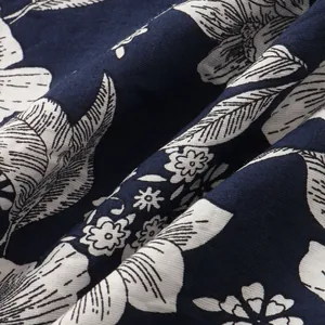 Detailed macro view of navy blue cotton linen fabric featuring an elegant white floral pattern