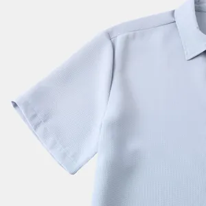 Close-up detail of light blue textured fabric on men's casual short sleeve polo shirt