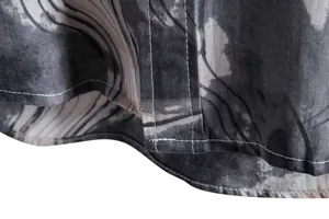Detailed macro view showing the high-quality stitching and marble print on men's shirt