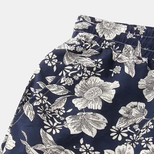 Detail shot of men's floral cotton linen shorts showing elastic waistband and pocket