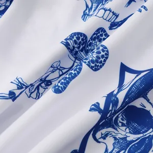 Macro view showing the intricate blue skull and floral print on soft white shirt fabric