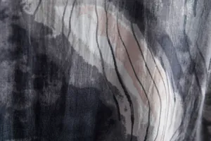 Macro view showing the detailed marble pattern and stripe print on men's casual shirt fabric