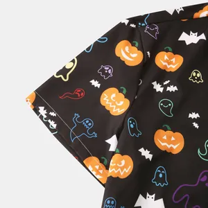Detailed view of Halloween print with pumpkins and ghosts on black shirt fabric