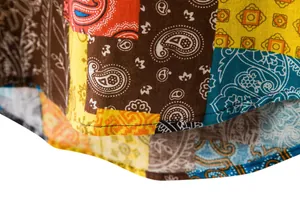 Close-up of men's cotton linen shirt with colorful patchwork paisley pattern hem