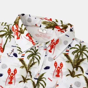 Close-up detail of the tropical lobster and palm tree print on this men's beach shirt
