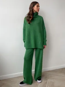 Macro view of thick green knitted two-piece set featuring oversized turtleneck sweater.