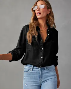 Close-up detail of a women's black long-sleeve casual denim shirt with front pockets