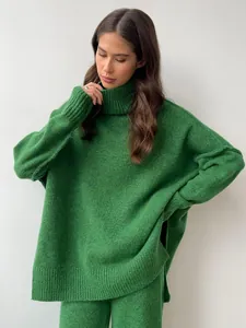 A close-up view of a cozy green thick knitted turtleneck sweater and matching trousers set