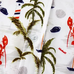 Detailed close-up of a men's tropical print beach shirt with palm trees and buttons