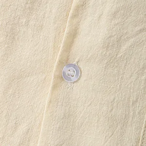 Macro detail of breathable linen fabric and button on men's summer casual shirt