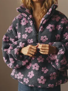 Gedetailleerd overzicht van een comfortabele damesfleece trui met grijs-roze bloemen.