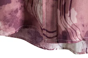 Close-up detail of the hem and stitching on a men's marbled stripe print casual shirt