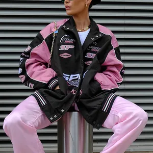 Detail showing the oversized fit and racing prints on the pink and black jacket
