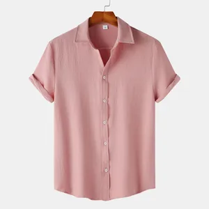 Close-up of pink textured short sleeve button down men's shirt with wooden hanger