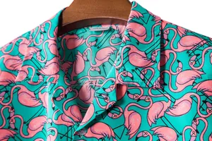 Detail of men's short-sleeved shirt featuring a vibrant pink flamingo print on teal