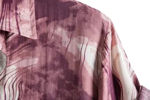 Close-up detail of abstract stripe print and shoulder seam on men's casual shirt